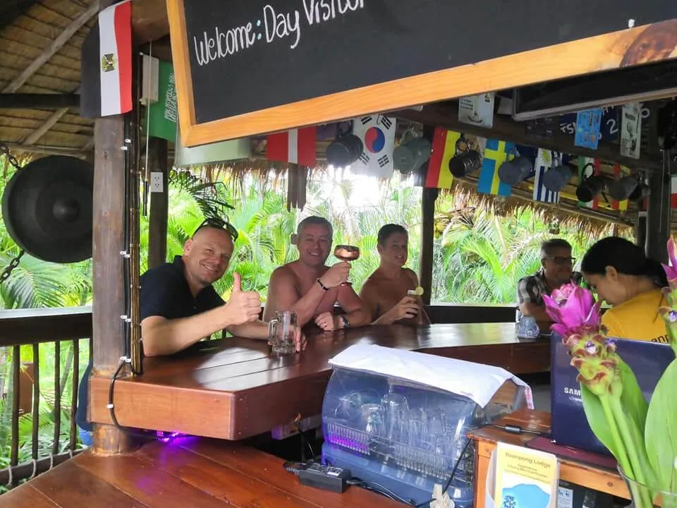 Guests at the bar under the welcome board