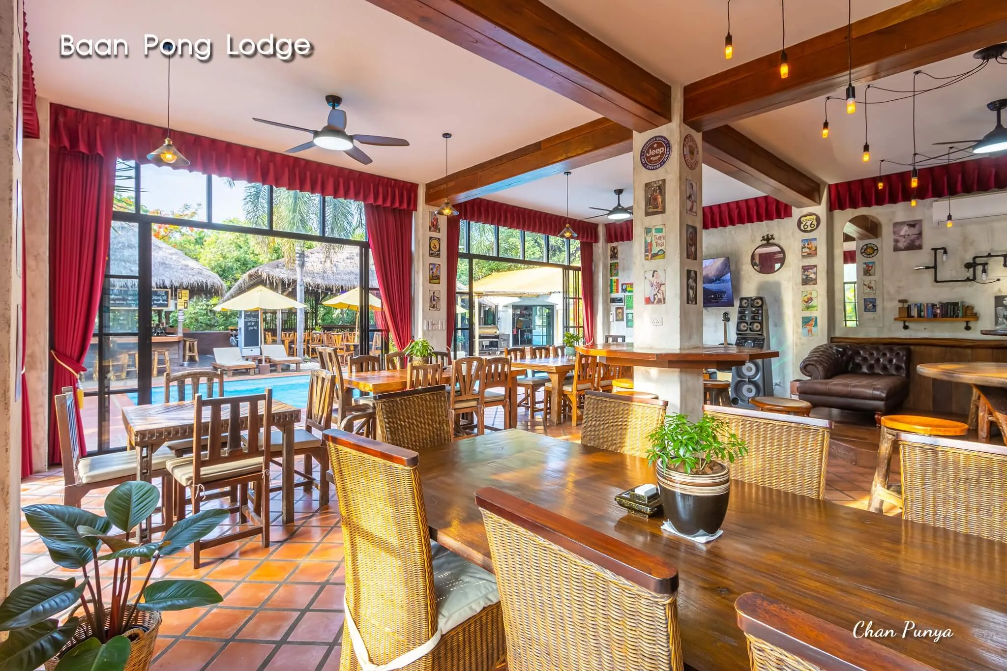 The restaurant from the bar end, tables laid and ceiling fans turning