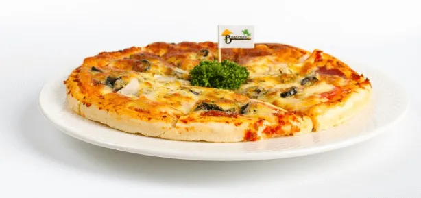 A thin-crust pizza, whole and sliced, on a white plate