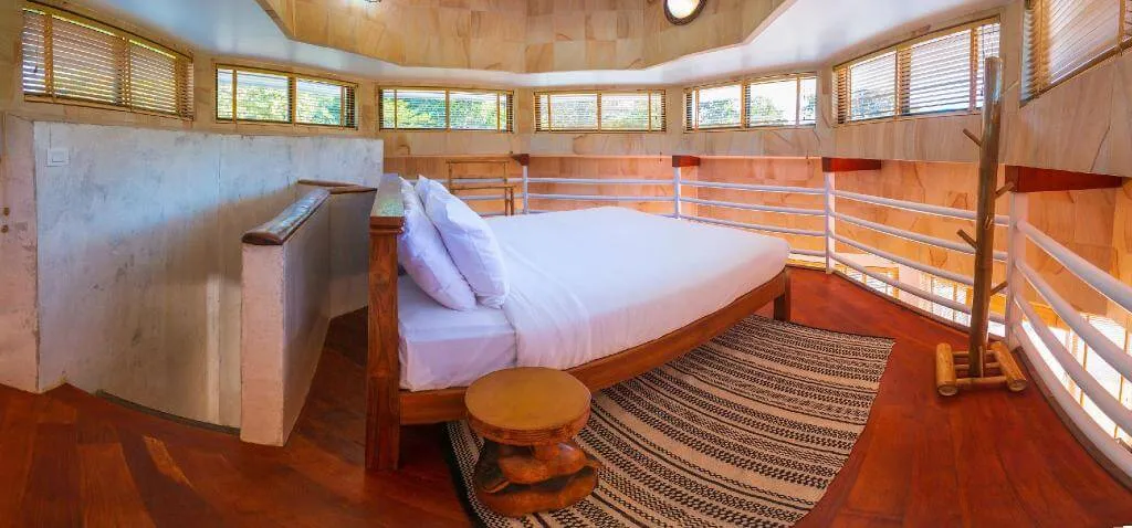 The loft bedroom, with a king bed and windows on every side