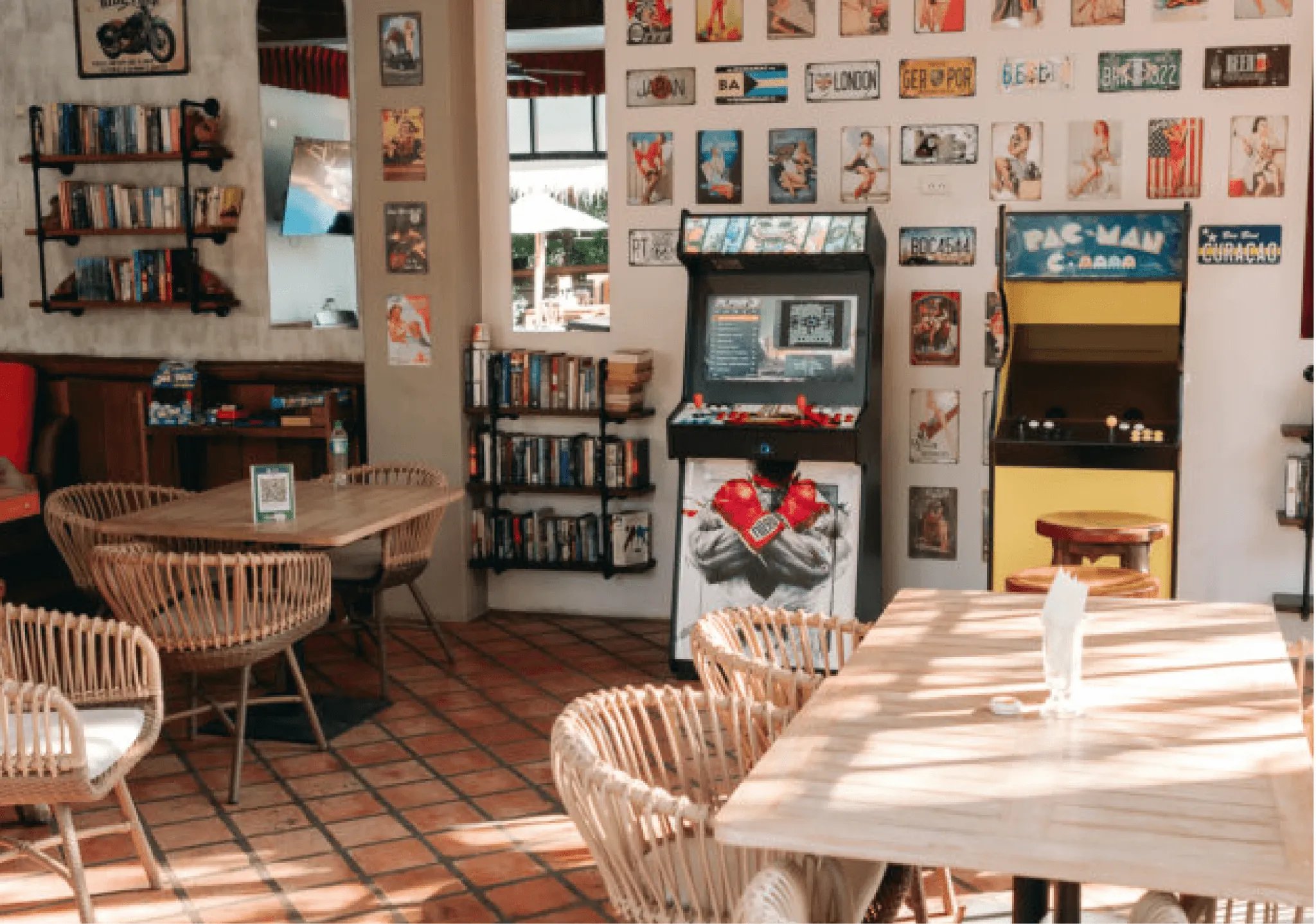 The games room: both cabinets against the poster wall, with the board games on the shelves behind the tables