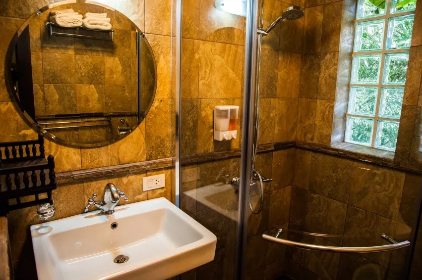 A chalet bathroom, with a glass shower and a wide basin