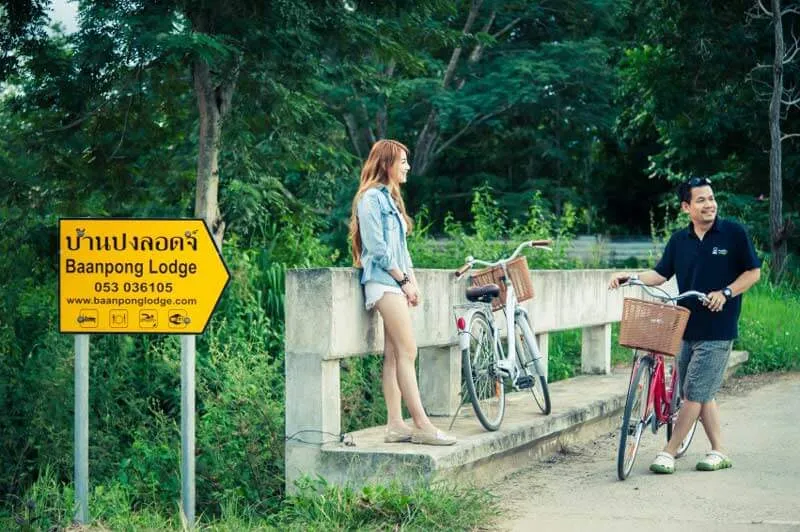 Two bicycles at the lodge sign on the lane