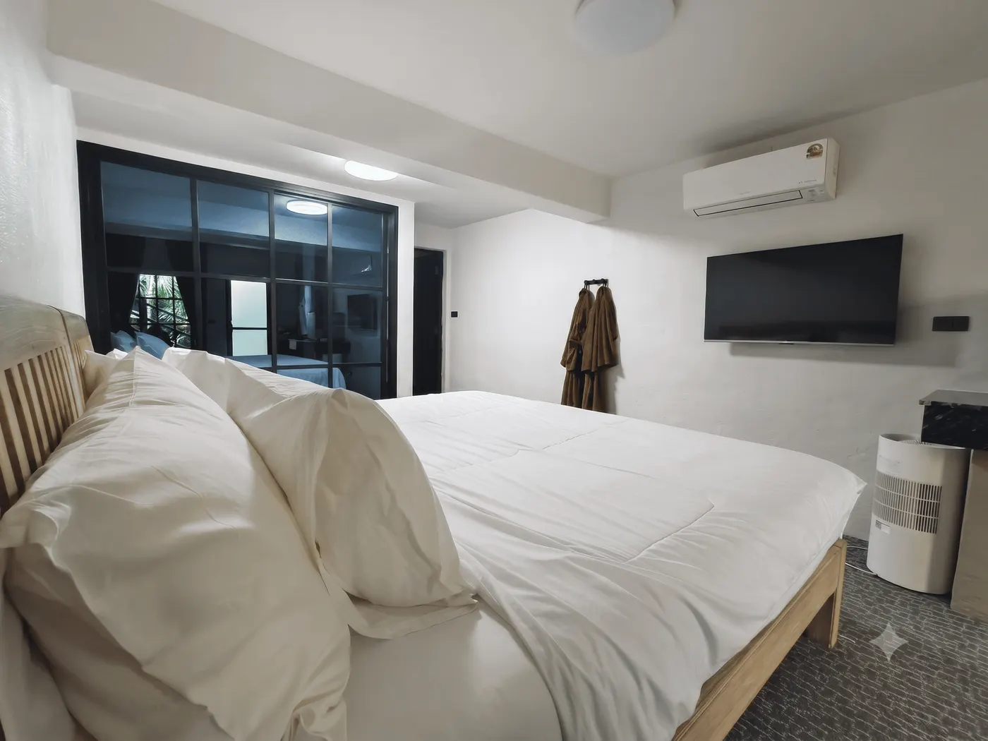 A refurbished room, with a king-sized bed, air conditioning and a flat-screen television
