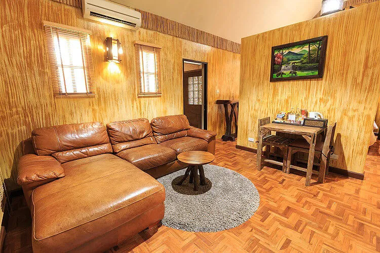 A room’s leather sofa, desk and tea tray