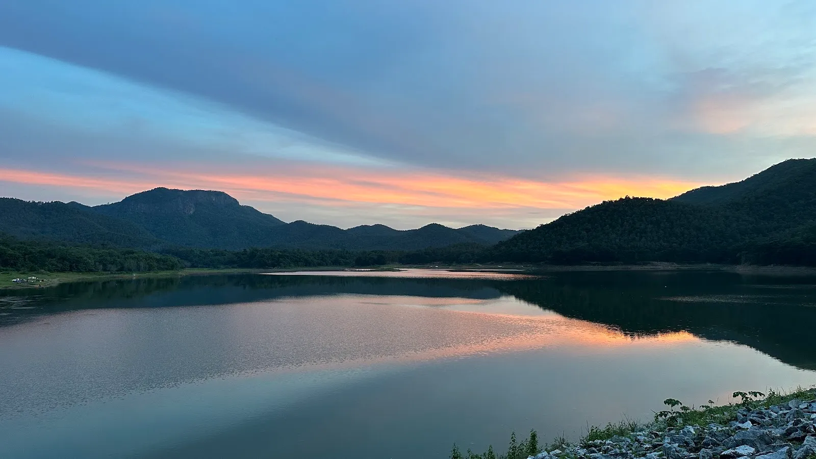 Huai Lan Reservoir at dusk, the hills dark against a pink sky