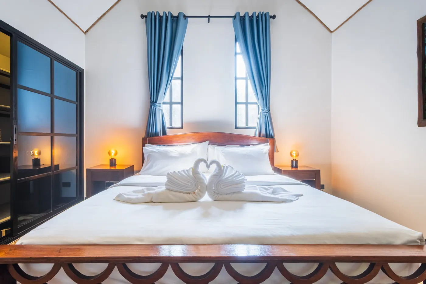 The king bed in a family junior suite, made up with towel swans