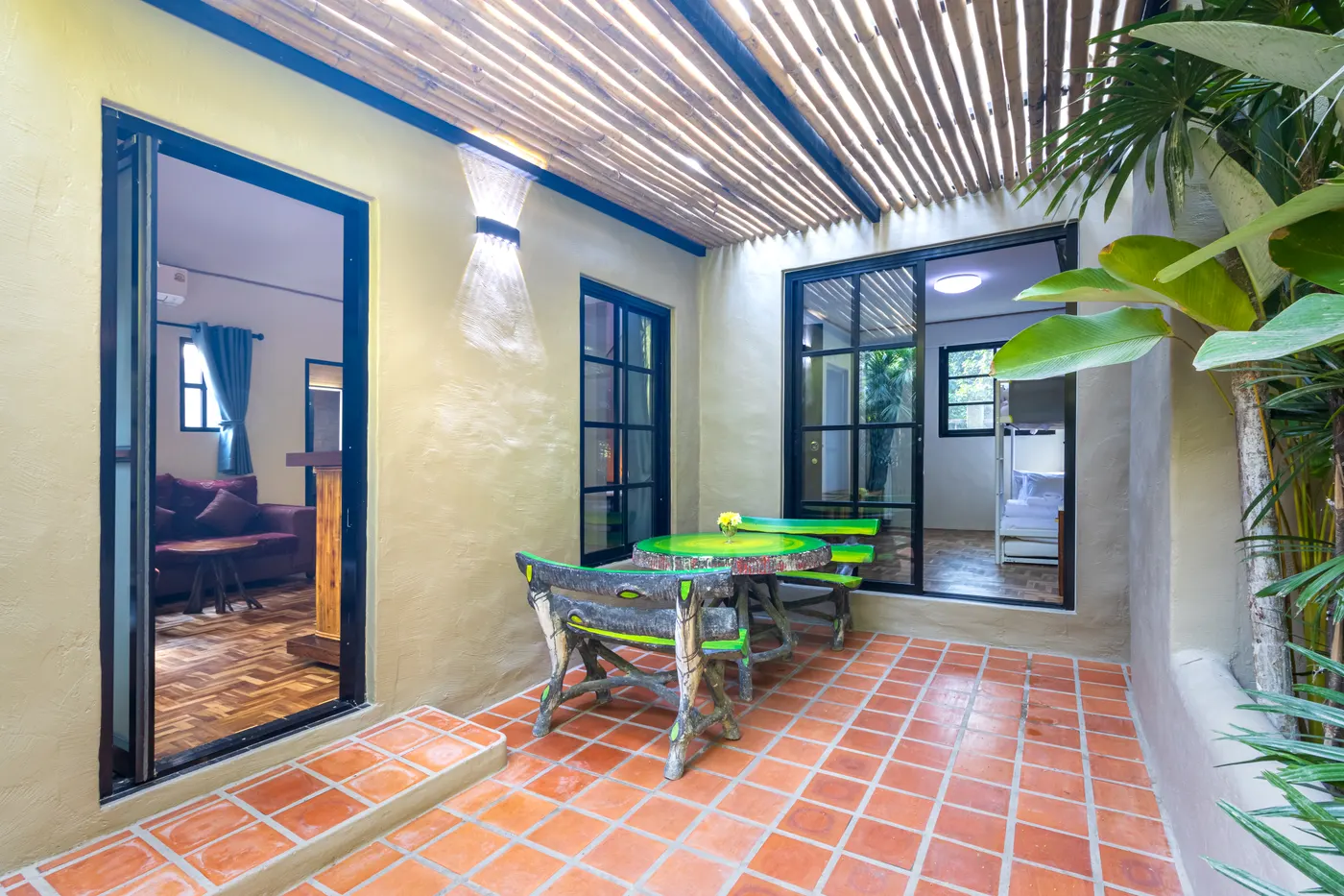 The terrace outside the suite, with a table under the slatted roof