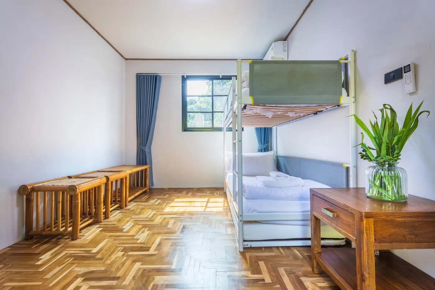 The adjoining room, with bunk beds, a television and a desk