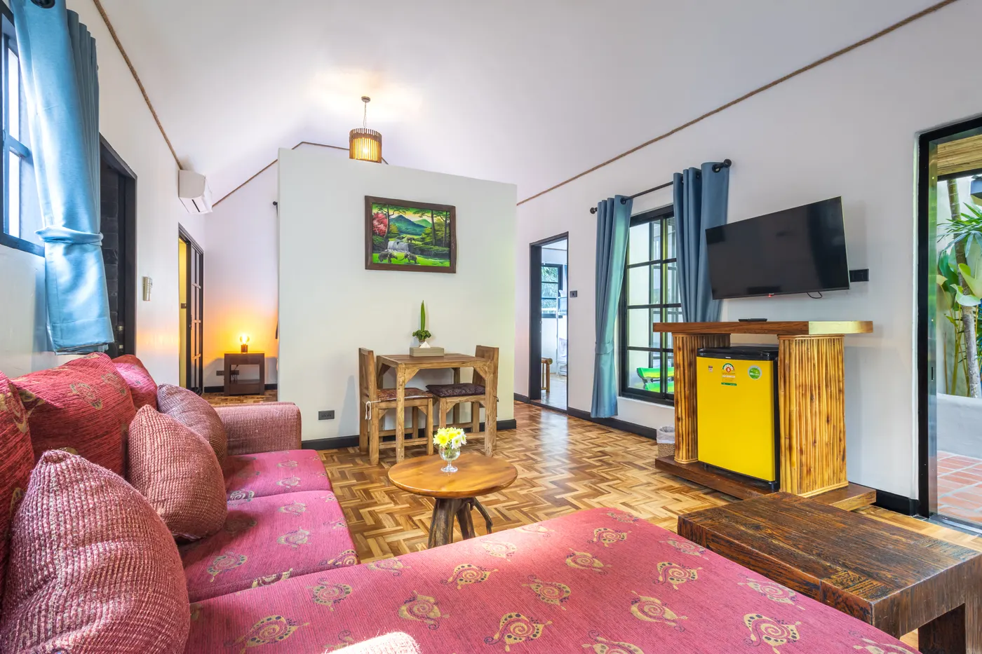 The living room of a family junior suite, with a sofa, a dining table and a television