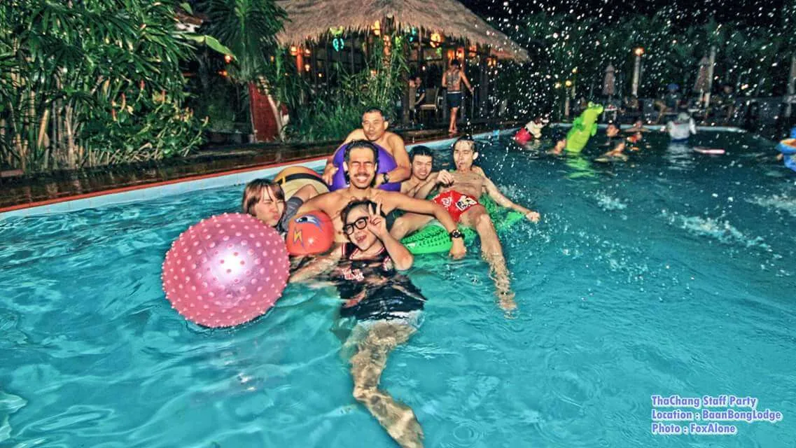 Guests in the pool with floats at a party