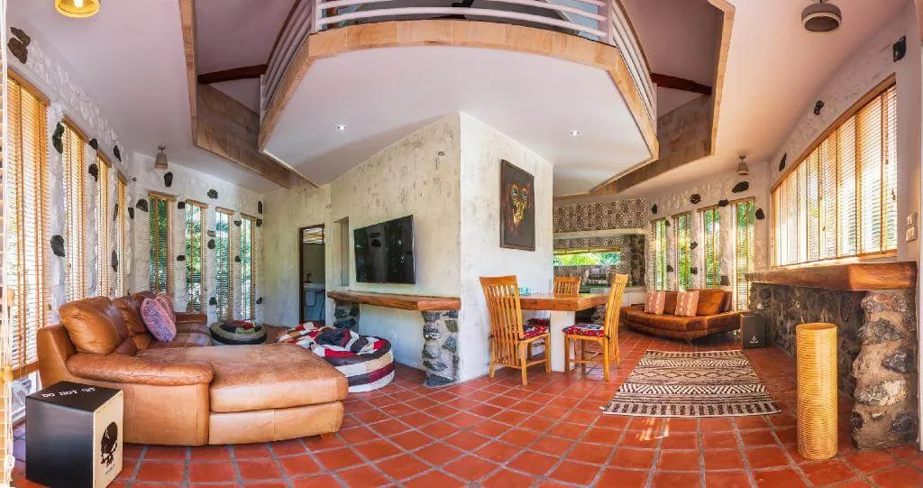 The cottage from the door, with the loft overhead and the dining table beyond