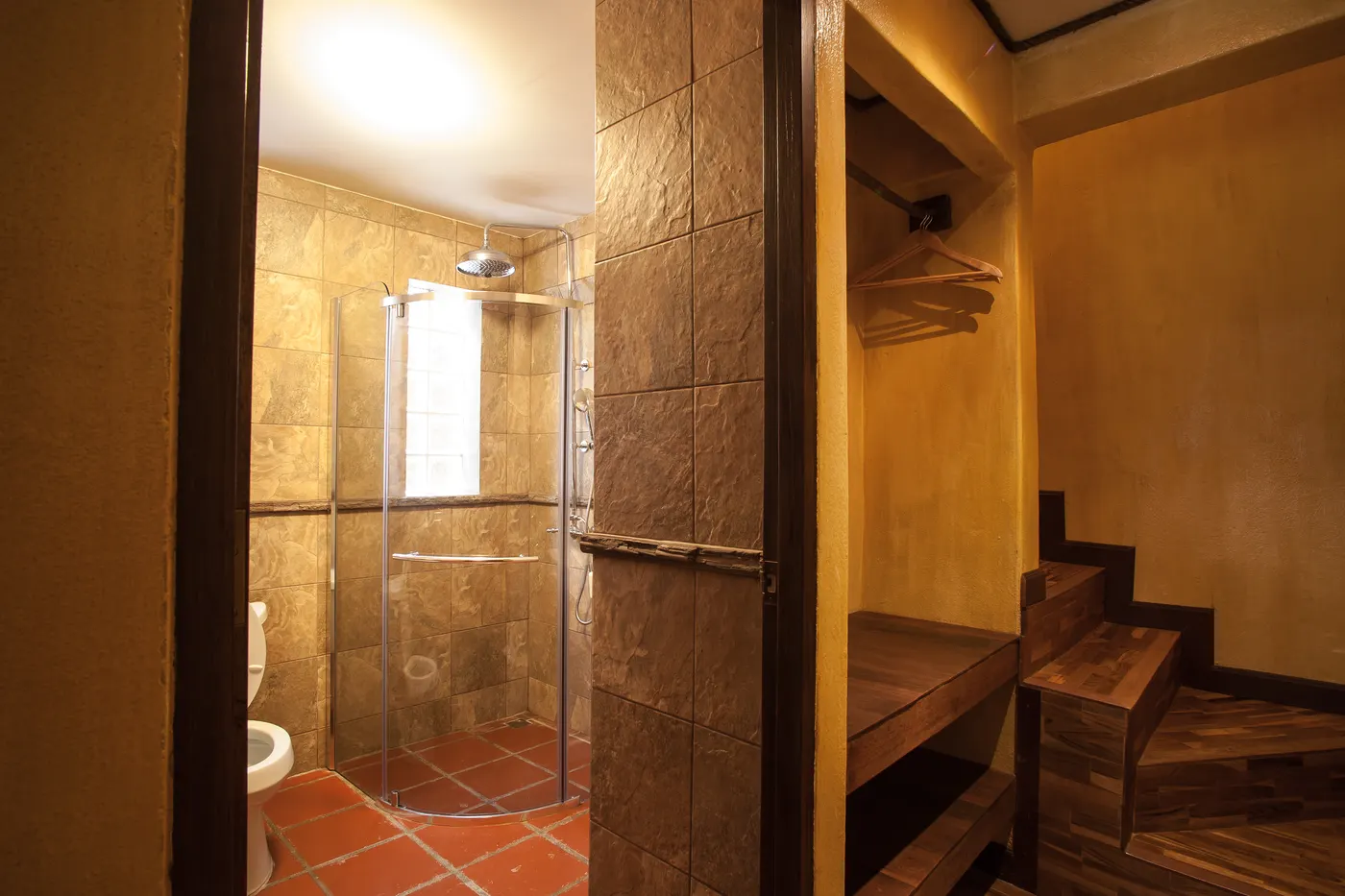 The shower room, with the wooden cupboard and steps beside it