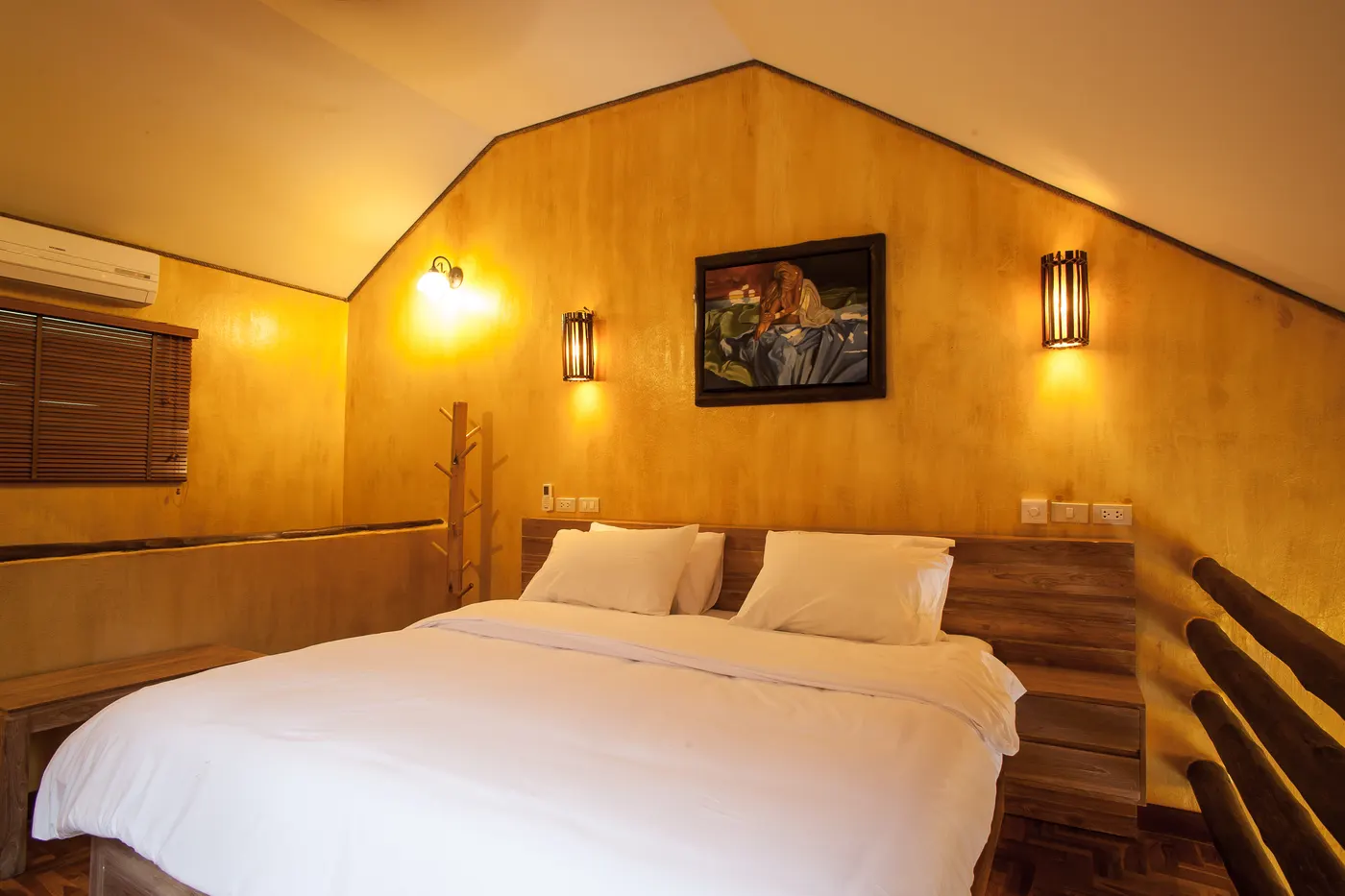 The sleeping level of a loft chalet, made up with a king-sized bed