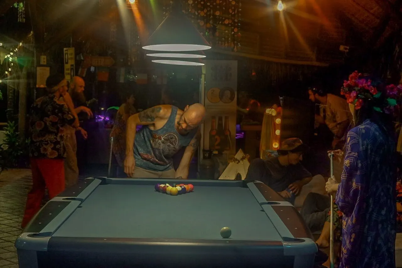 Lining up a shot at the pool table in the evening