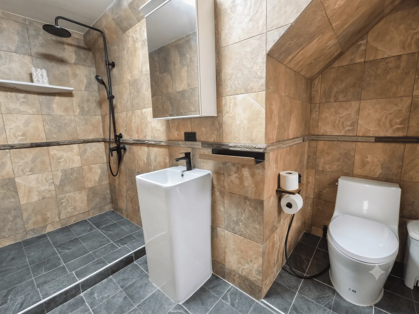 The bathroom, with a rain shower over stone tiles and a tall basin