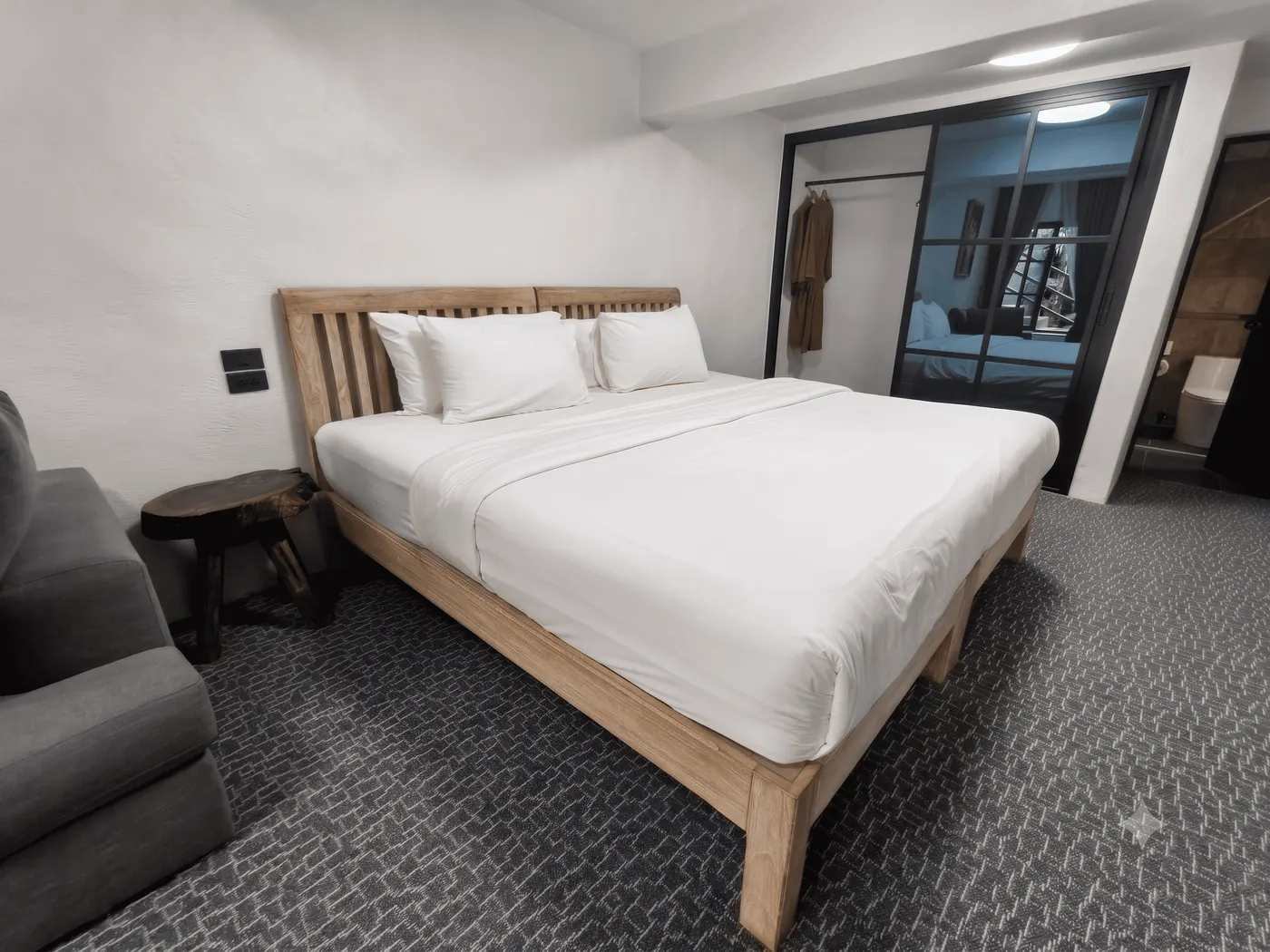 The room from the doorway, with an armchair beside the bed