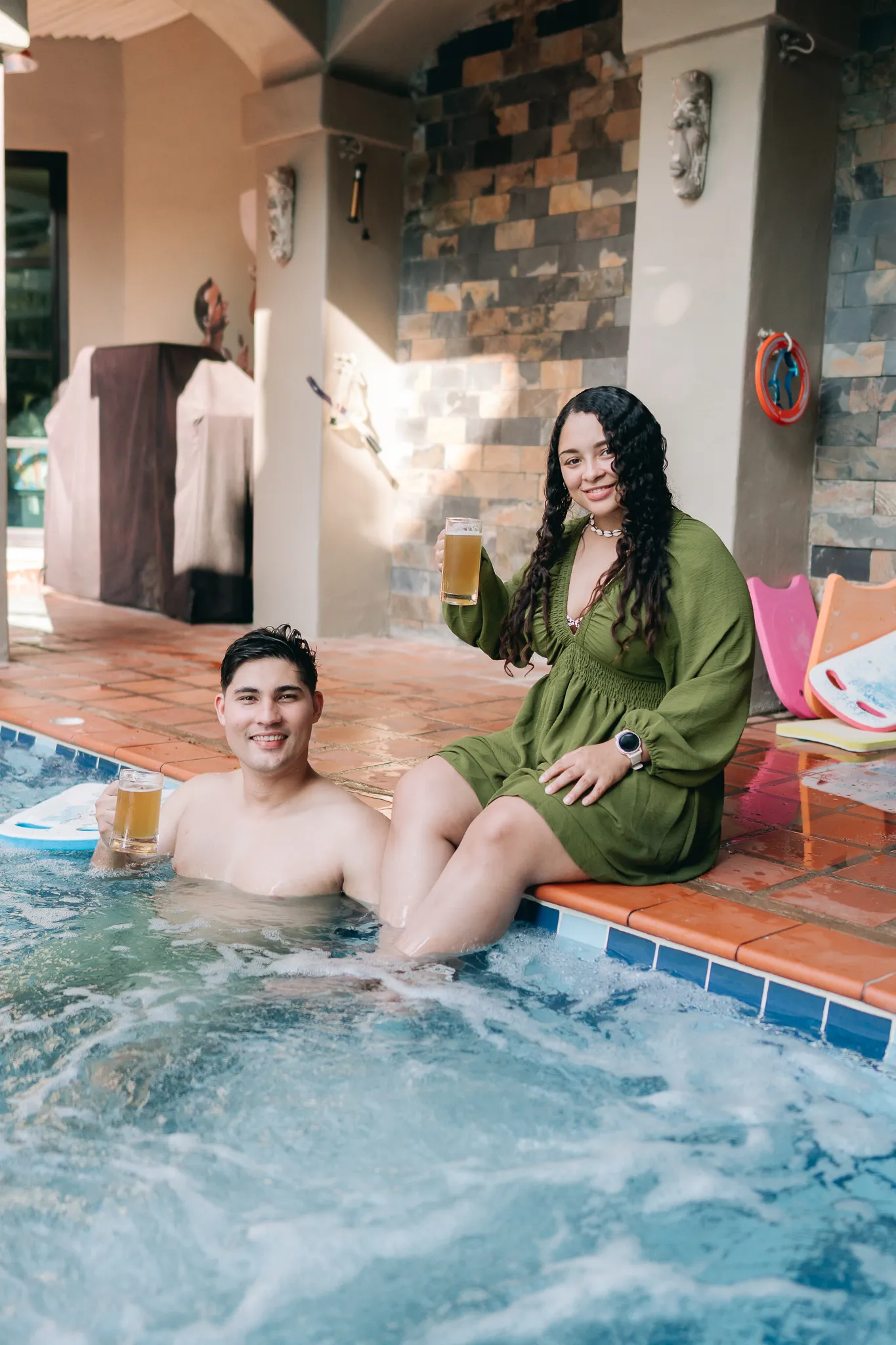 Two guests with beers in the bubbling hot tub