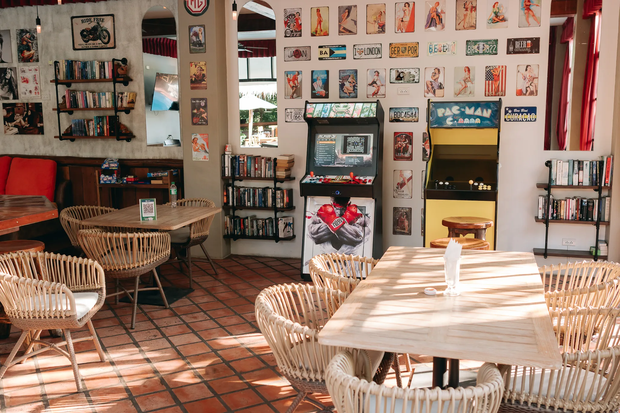 The games room, its arcade cabinets and shelves of films under framed prints