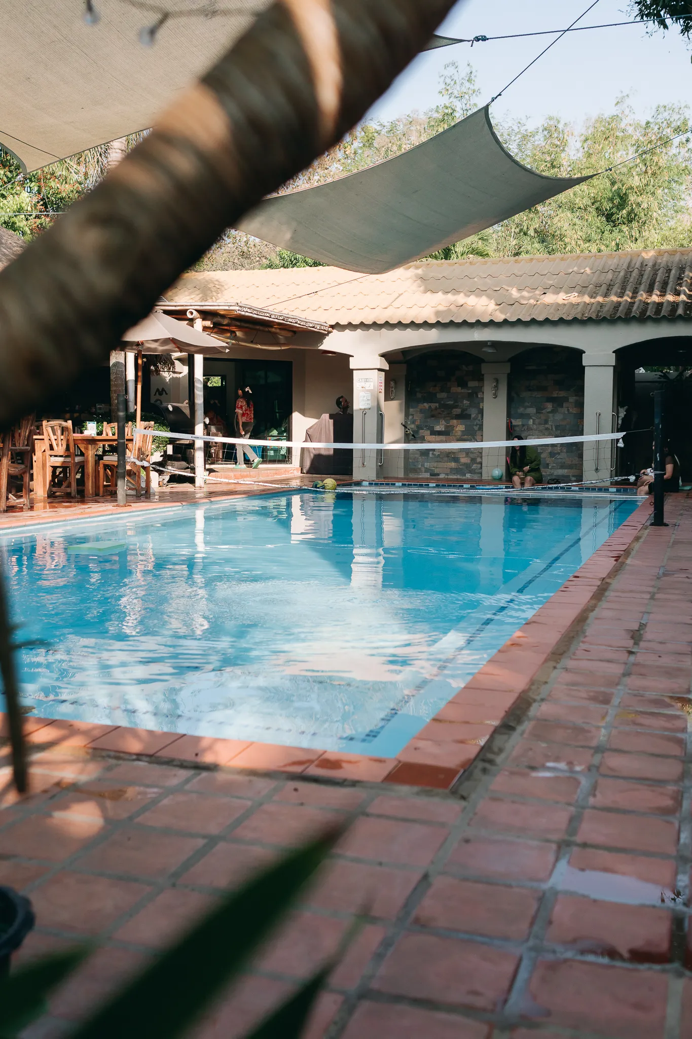 The swimming pool under its shade sails, the arched terrace beyond