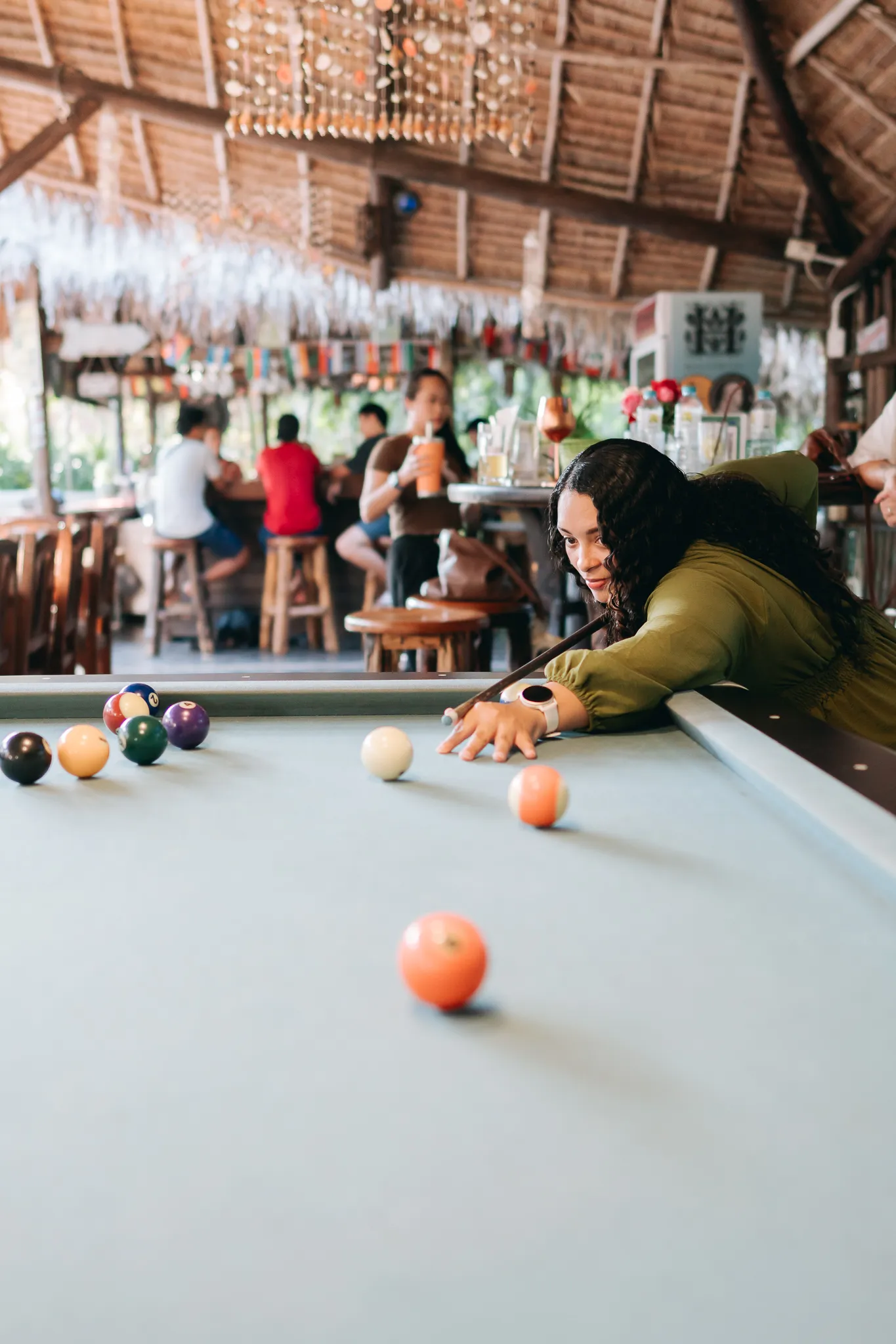 A game of pool at the table beside the bar